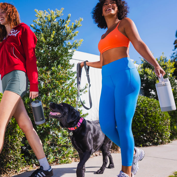 32oz_2_in_1_Triple_walls_Insulated_Stainless_Steel_water_bottle_Life style image_carries_jug_with_dog